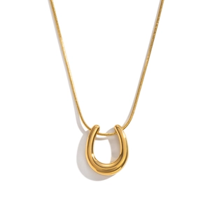 Detailed macro view of 18K gold plated U-shaped horseshoe pendant and sleek snake chain