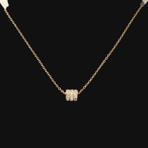 Detail of gold titanium necklace with a triple-row zircon encrusted cylinder pendant