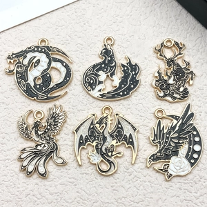Set of 6 black and white enamel mythical creature charms with dragon, phoenix, and moon