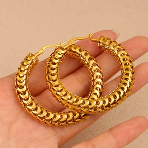 Exaggerated 18K gold plated hollow hoop earrings with textured scale pattern on palm