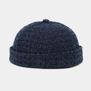 Detailed view of dark blue textured docker hat with vintage washed denim aesthetic