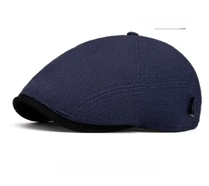Detail of navy blue flat cap featuring breathable mesh fabric and black visor trim