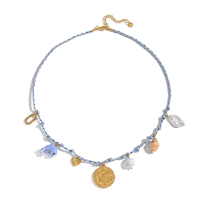 Detail of blue woven necklace with golden heart, dolphin, and baroque pearl charms