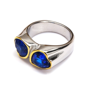 Close-up of heart-shaped blue gemstones with gold edging on a silver ring band