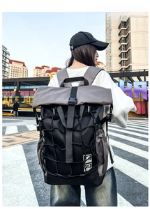 Close-up of functional roll-top backpack with elastic bungee cords and modular design