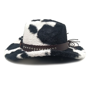 Detail of cow print cowboy hat showing plush faux fur texture and studded leather band