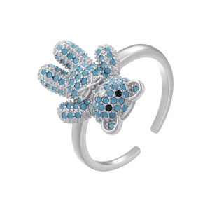 Detailed view of silver bear ring featuring turquoise stones and an adjustable open band