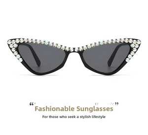 Detail shot of black cat-eye sunglasses featuring rhinestones and dark grey lenses