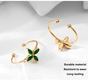 Detail of 18k gold plated four-leaf clover ring with green marquise-cut zircons