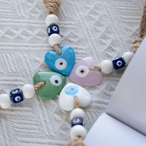 Blue evil eye heart wall hanging decor with colorful glass beads and jute rope