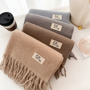 Chic thick wool-like scarves in neutral tones with fringe and stylish tassels