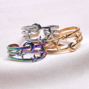 Close-up of moon and star hollow rings in silver, gold, and rainbow metallic finishes