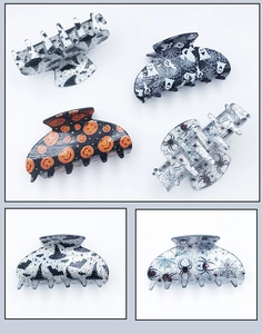 Collection of Halloween acrylic hair claws with pumpkin, ghost, and bat patterns