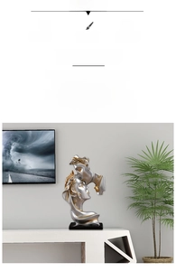 Close-up of abstract resin kiss sculpture with silver and gold finish detailing