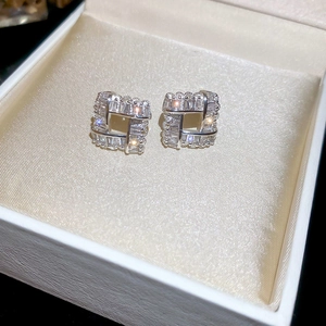 Elegant square silver earrings with cubic zirconia inlay on a white jewelry box