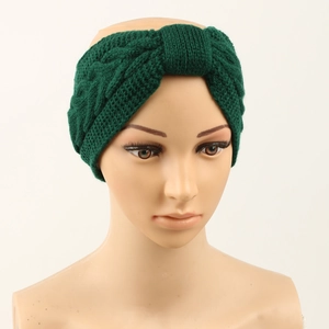 Detail of dark green cable knit headband with warm fleece lining on a model head