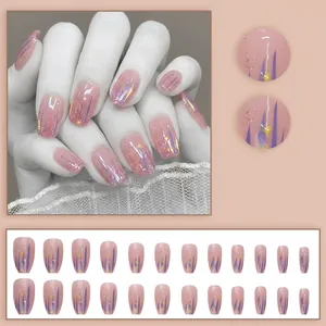 Pink press-on nails set with purple swirls, gold glitter, and yellow star accents