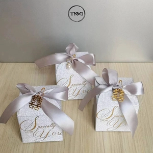 Elegant silver glitter wedding favor box with grey satin ribbon and golden xi pendant