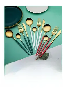 Flat lay of luxury gold-plated stainless steel cutlery sets with colorful matte handles
