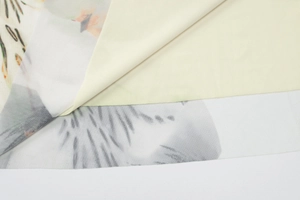 Detail of floral mesh fabric with solid lining showing layered texture and quality