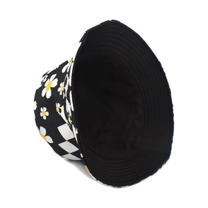 Close-up of double-sided bucket hat featuring daisy floral print and checkerboard pattern