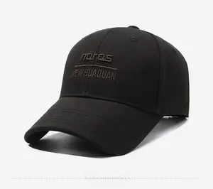 Close-up of black cotton baseball cap featuring brown embroidered urban leisure text