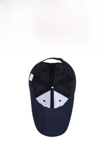 Detail view of breathable laser-cut mesh and adjustable strap on a dark blue cap