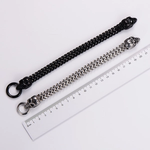 Detail of dual-row woven steel bracelets with skull heads and O-ring clasps