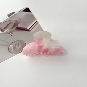 Detailed view of iridescent starry hair claw clip with pink gradient and golden glitters