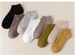 Detail view of eight multi-color cotton ankle socks featuring ribbed cuffs and soft texture