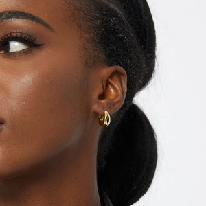 Chic gold-plated huggie hoop earrings for women shown on model for daily style