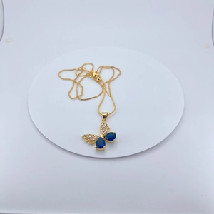 Gold plated butterfly necklace with blue zircon teardrop crystals on white display