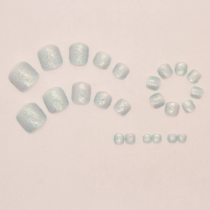 Detailed view of light blue glitter press-on toenails with aurora laser shimmer finish
