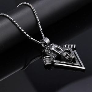 Macro detail of gothic tiger skull pendant on box chain with oxidized steel finish