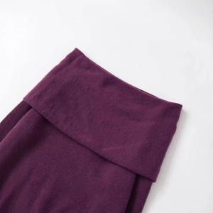 Deep purple off-shoulder knit sweater showing fine texture and folded fabric detail
