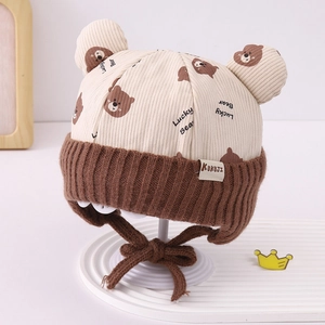 Detail of baby bear ear corduroy hat with soft knit trim and cute Lucky Bear print