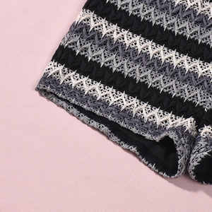 Detail of black, white and grey crochet wave pattern on two-piece knit summer set