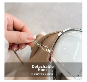 Macro shot of detachable silver chain hook and textured white acrylic crossbody bag detail