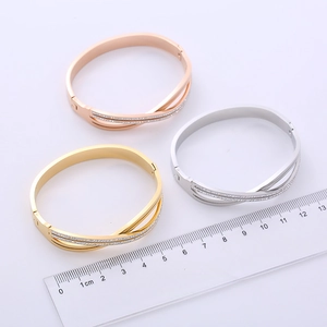 Cross-shaped double-row bangle with crystals in gold, rose gold, and silver finishes