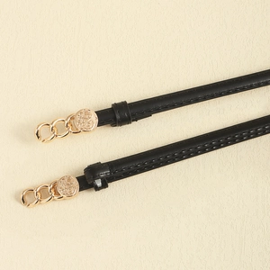 Slim black leather belt with golden circular decorative buckle for women's dresses