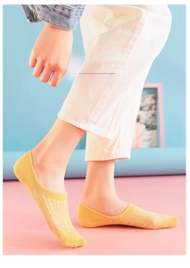 Detail of light yellow mesh invisible sock with breathable diamond knit pattern for summer