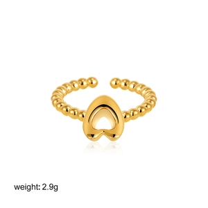 Detail of 18K gold beaded open ring with hollow heart design and smooth reflection