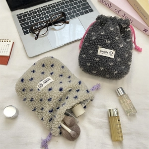 Macro view of plush polka dot pouches with drawstring and woven label for organization