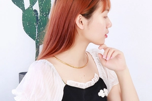 Detailed view of a model wearing a minimalist gold stainless steel square ring necklace