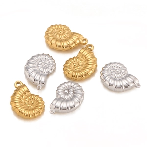 Macro view of 18K gold and silver nautical conch shell charms for DIY jewelry making