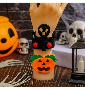 Detail of Halloween ghost and pumpkin snap bracelets with felt fabric and plush decor