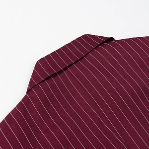 Close-up of burgundy oversized blazer collar with white pinstripe fabric texture