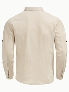 Detail view of the back of a light beige linen shirt showing breathable fabric texture