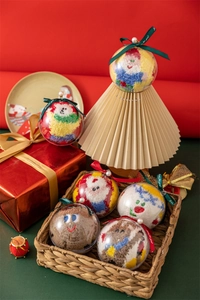 Close-up of Christmas coral fleece socks in a transparent festive ornament gift box