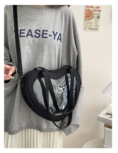 Detail of black heart ita bag with transparent window, dual handles and long strap